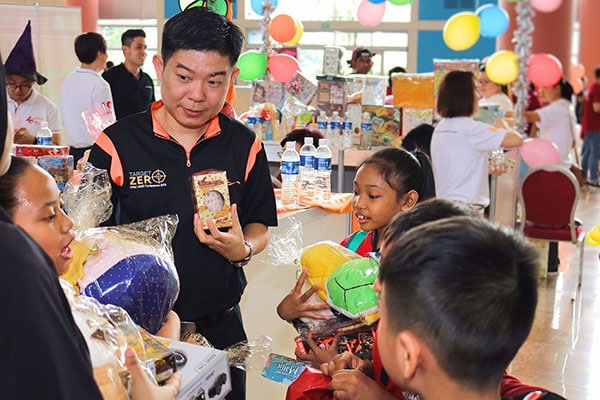 Singapore employees distribute toys to needy children